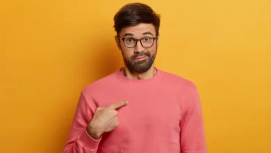 shot emotional bearded man points himself surprised being chosen asks question with shocked hesitant expression wears rosy sweater eyewear poses against yellow wall who me 273609 42222