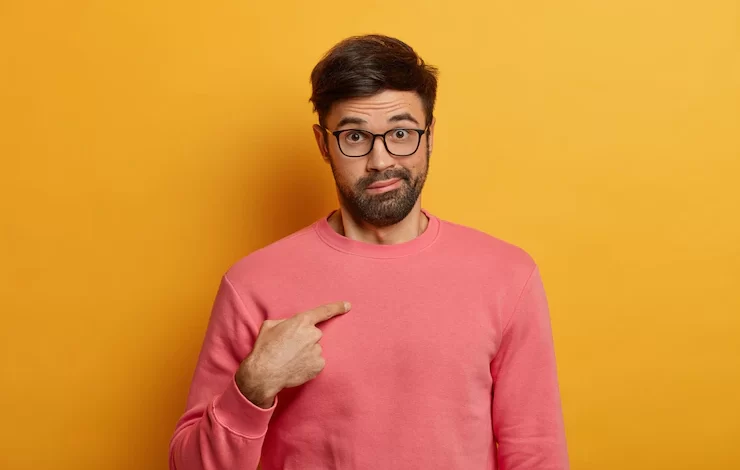 shot emotional bearded man points himself surprised being chosen asks question with shocked hesitant expression wears rosy sweater eyewear poses against yellow wall who me 273609 42222