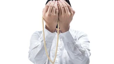 1643199 مرد مسلمان آسیایی در حال دعا با مهره های نماز بر روی دست هایش جدا شده روی پس زمینه سفید